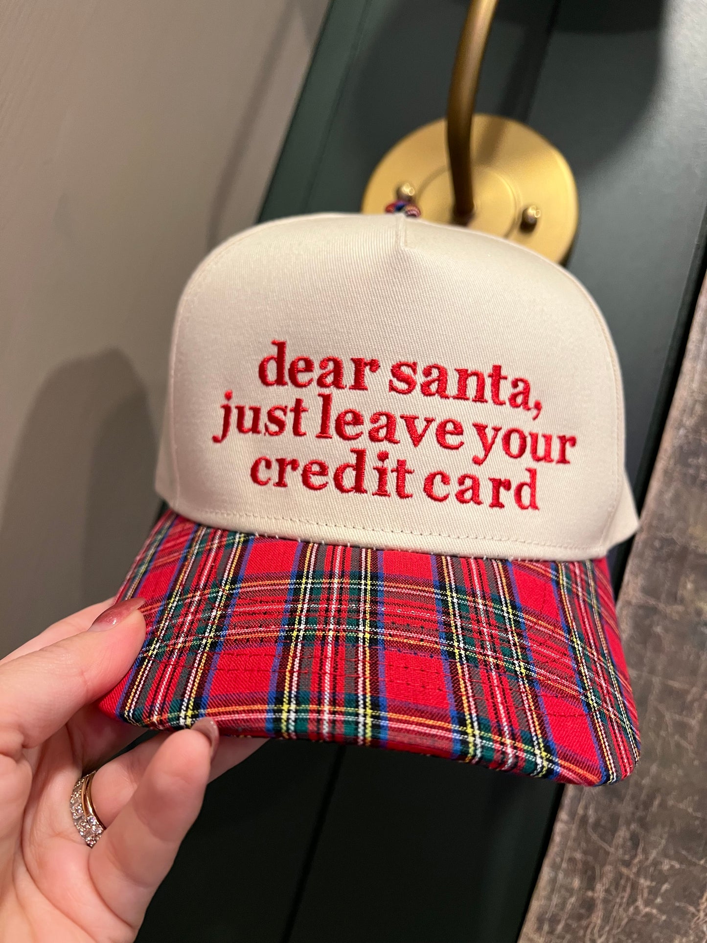 plaid and beige cap with wording on the front in embroidery.