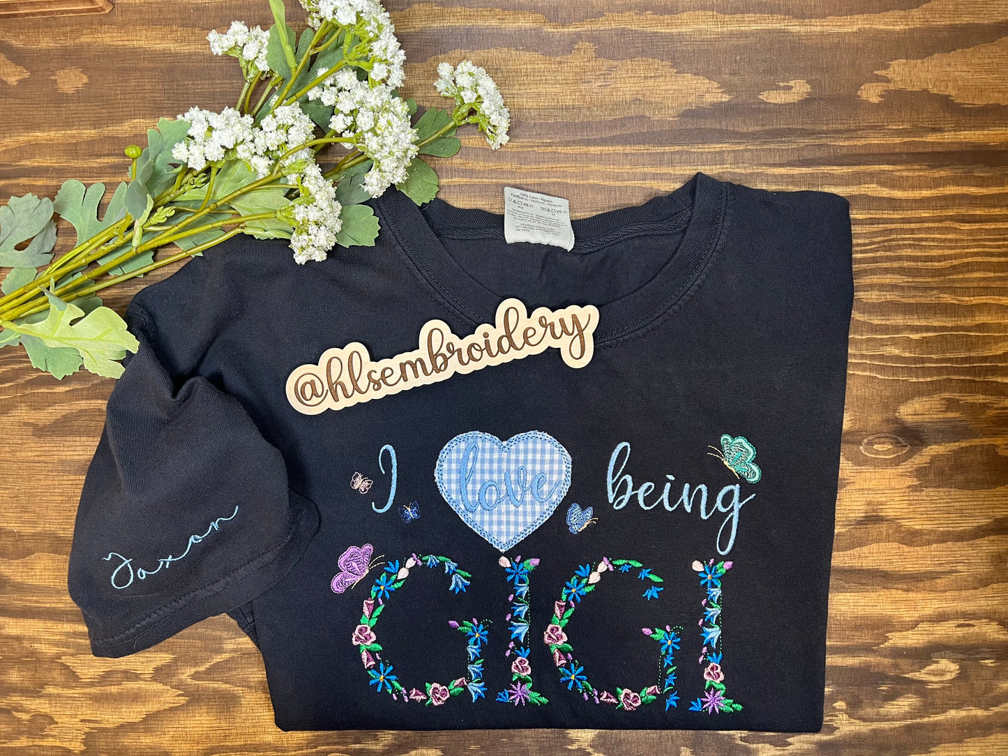 Embroidered "I love being GIGI" tshirt with sleeve personalization added