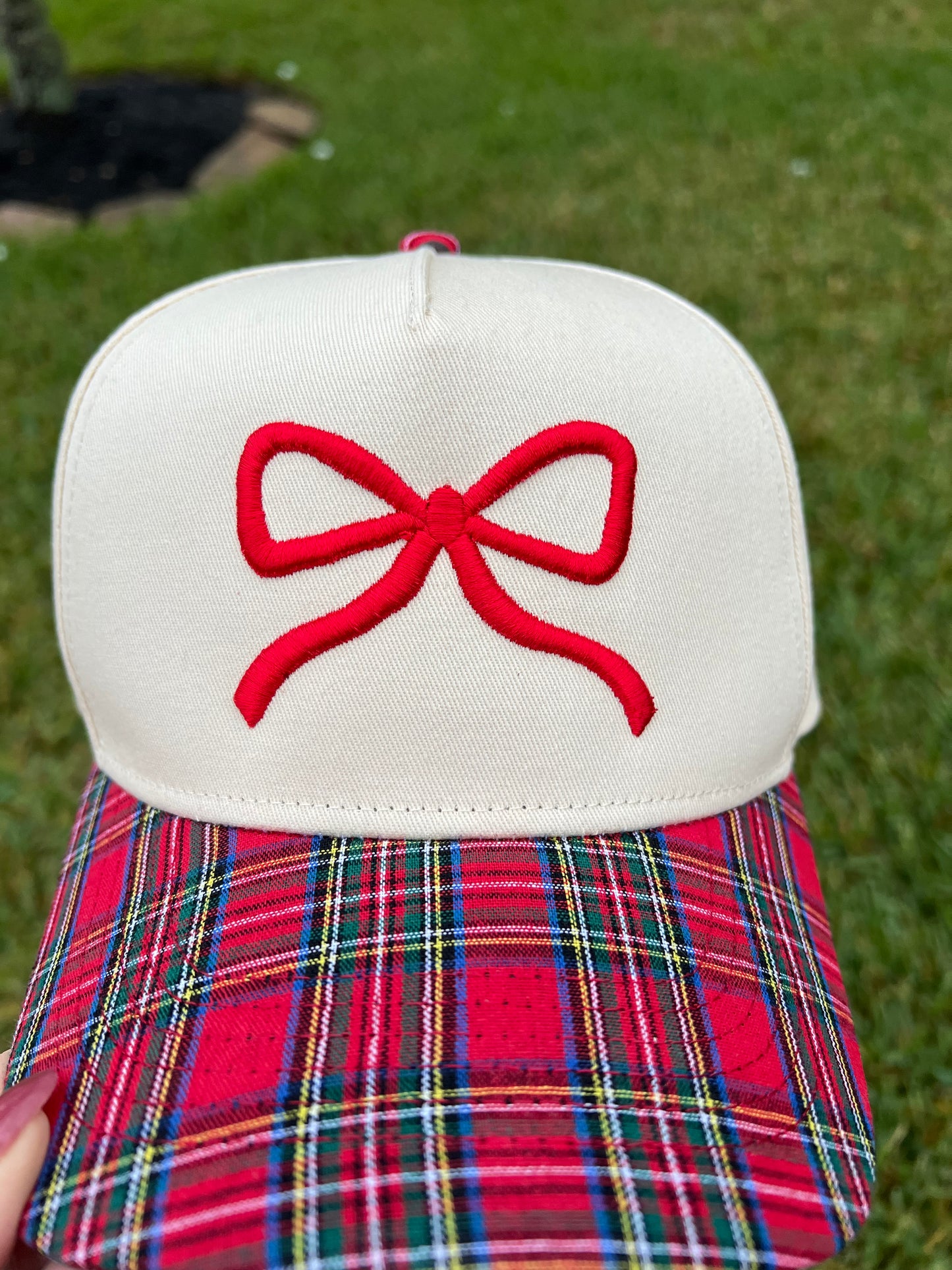 plaid and beige cap with puff bow embroidery.