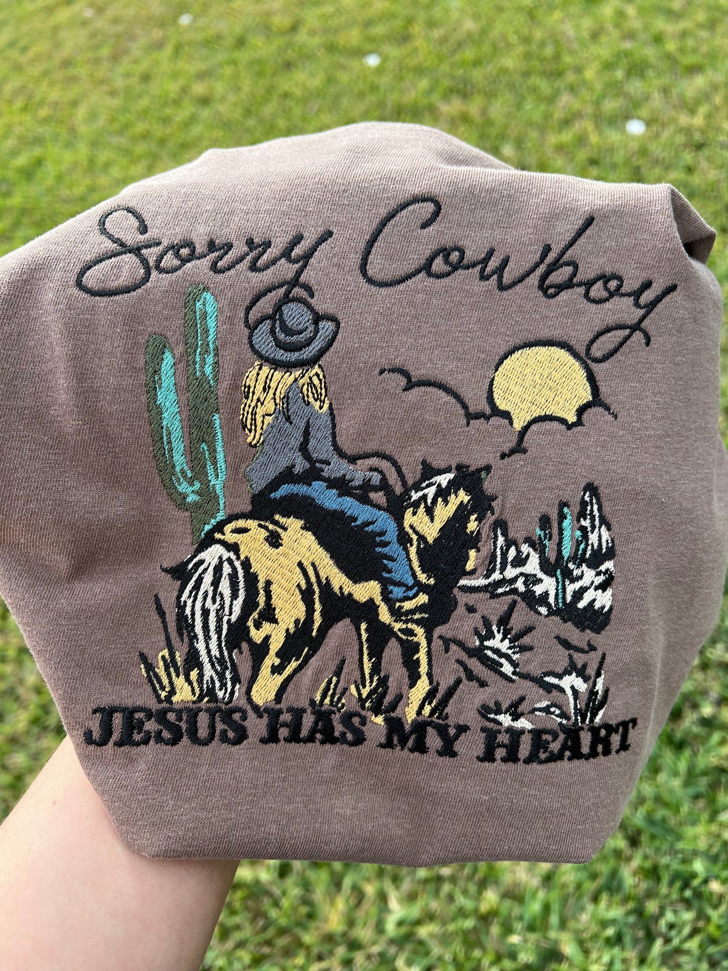 Folded t-shirt with 'Sorry Cowboy Jesus Has My Heart' embroidery design