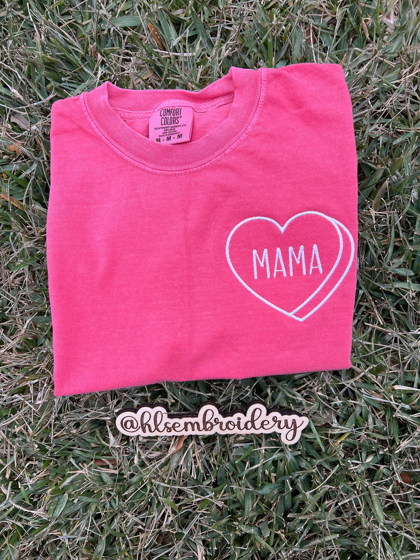 Pink shirt with embroidered heart with mama on the inside embroidered.