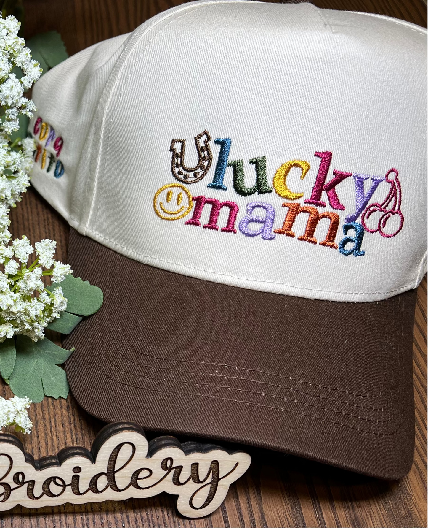 beige and brown hat with embroidered colorful wording and motifs "lucky mama"