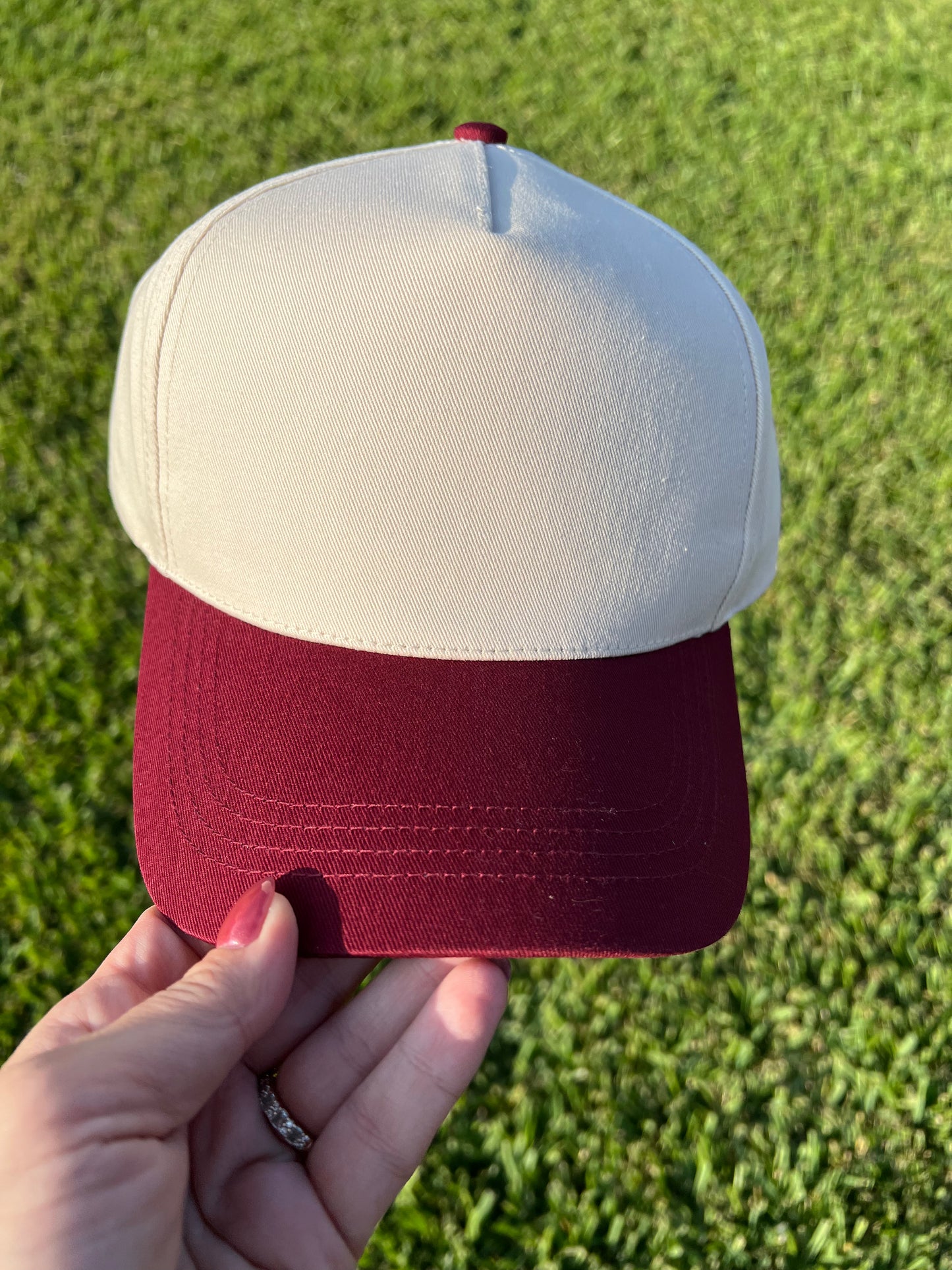 beige and maroon cap