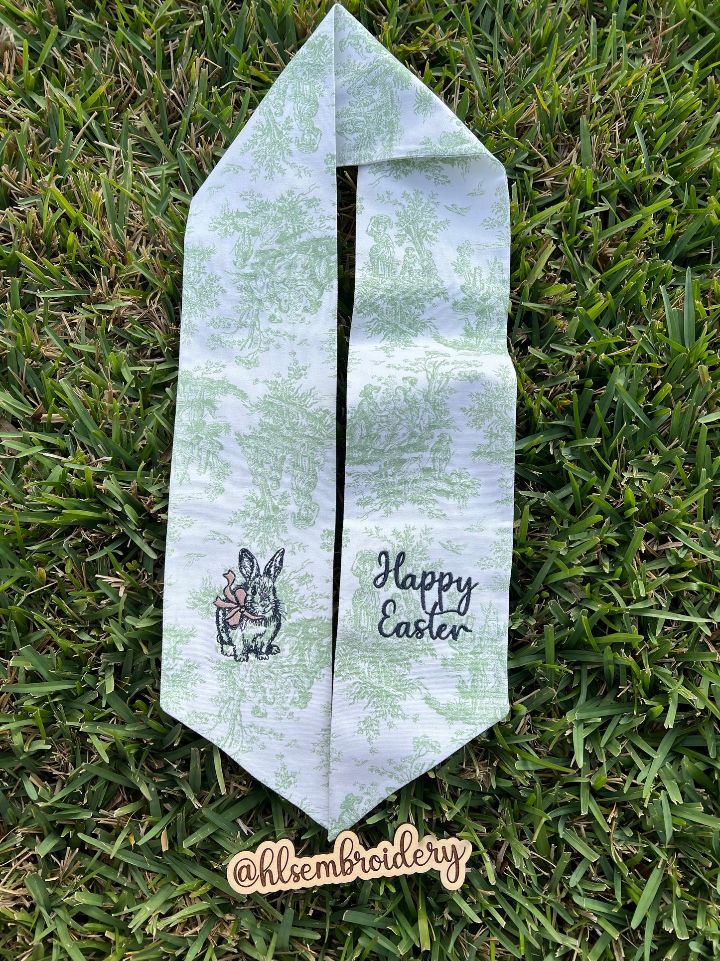 Green Toile Wreath sash with bunny and bow and happy Easter embroidered on it. 