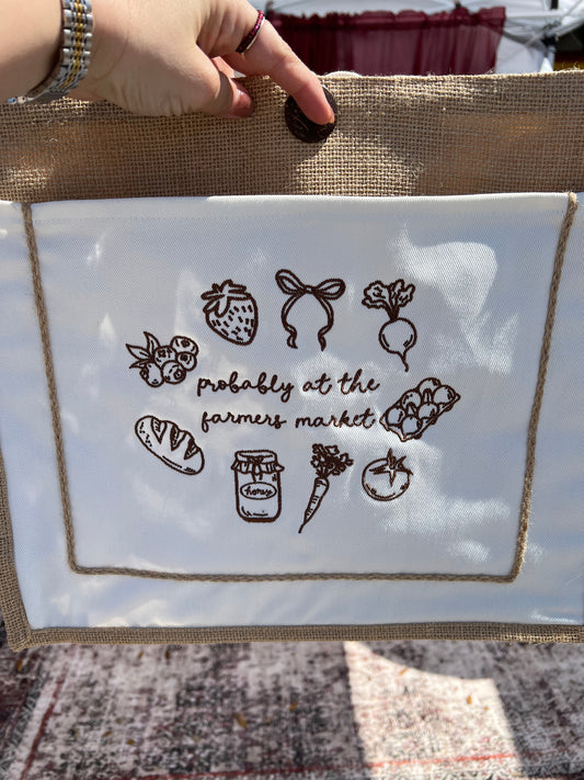 Tote bag with embroidered Probably at the farmers market with icons around the wording 