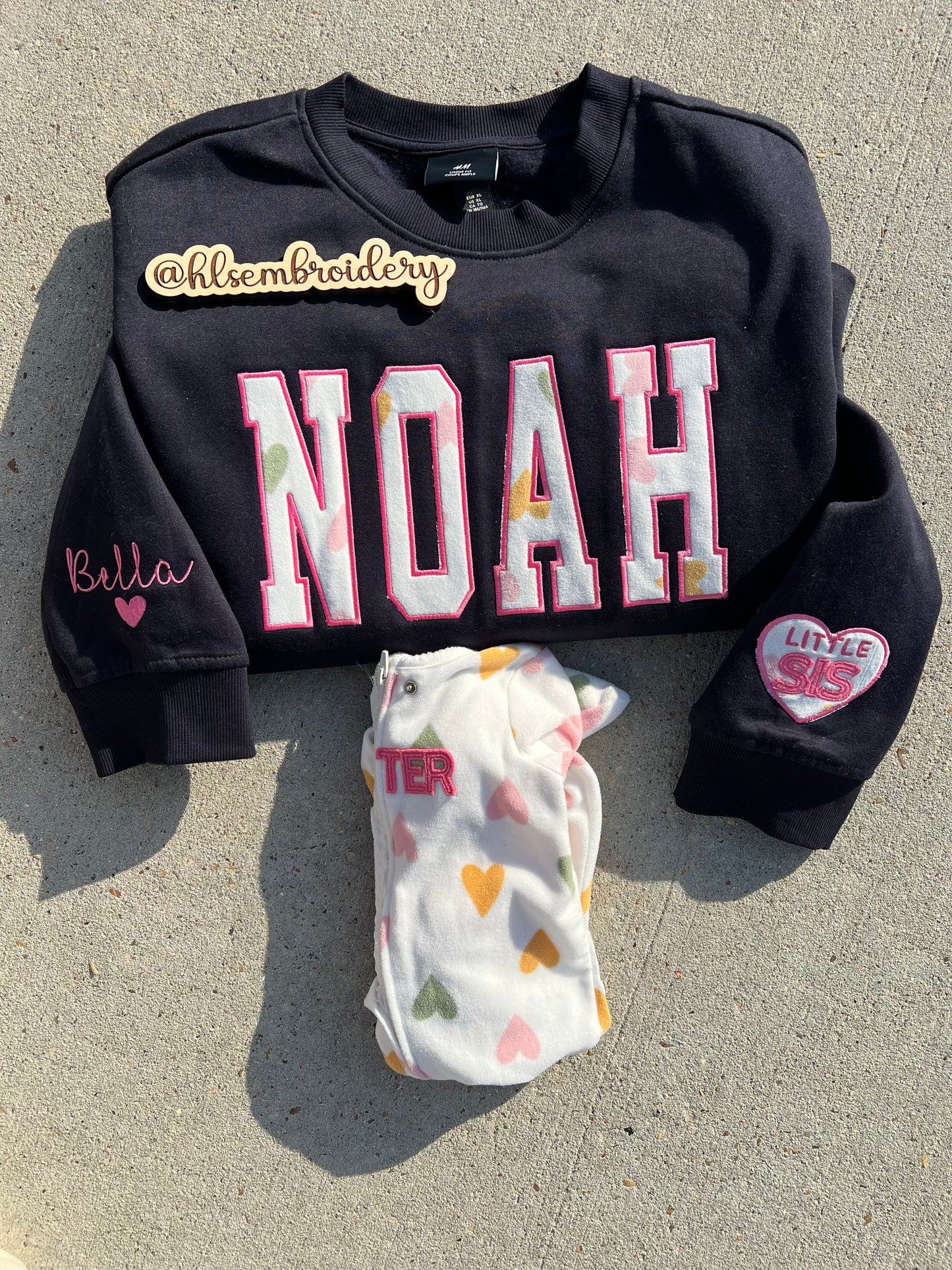 Custom name  embroidered crewneck using baby clothing and sleeve embroidered detail. 