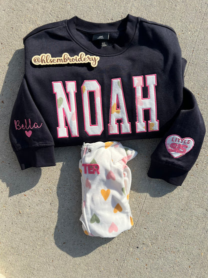 Custom name  embroidered crewneck using baby clothing and sleeve embroidered detail. 