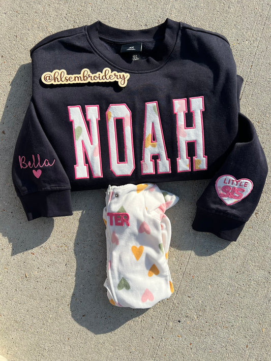 Custom name  embroidered crewneck using baby clothing and sleeve embroidered detail. 
