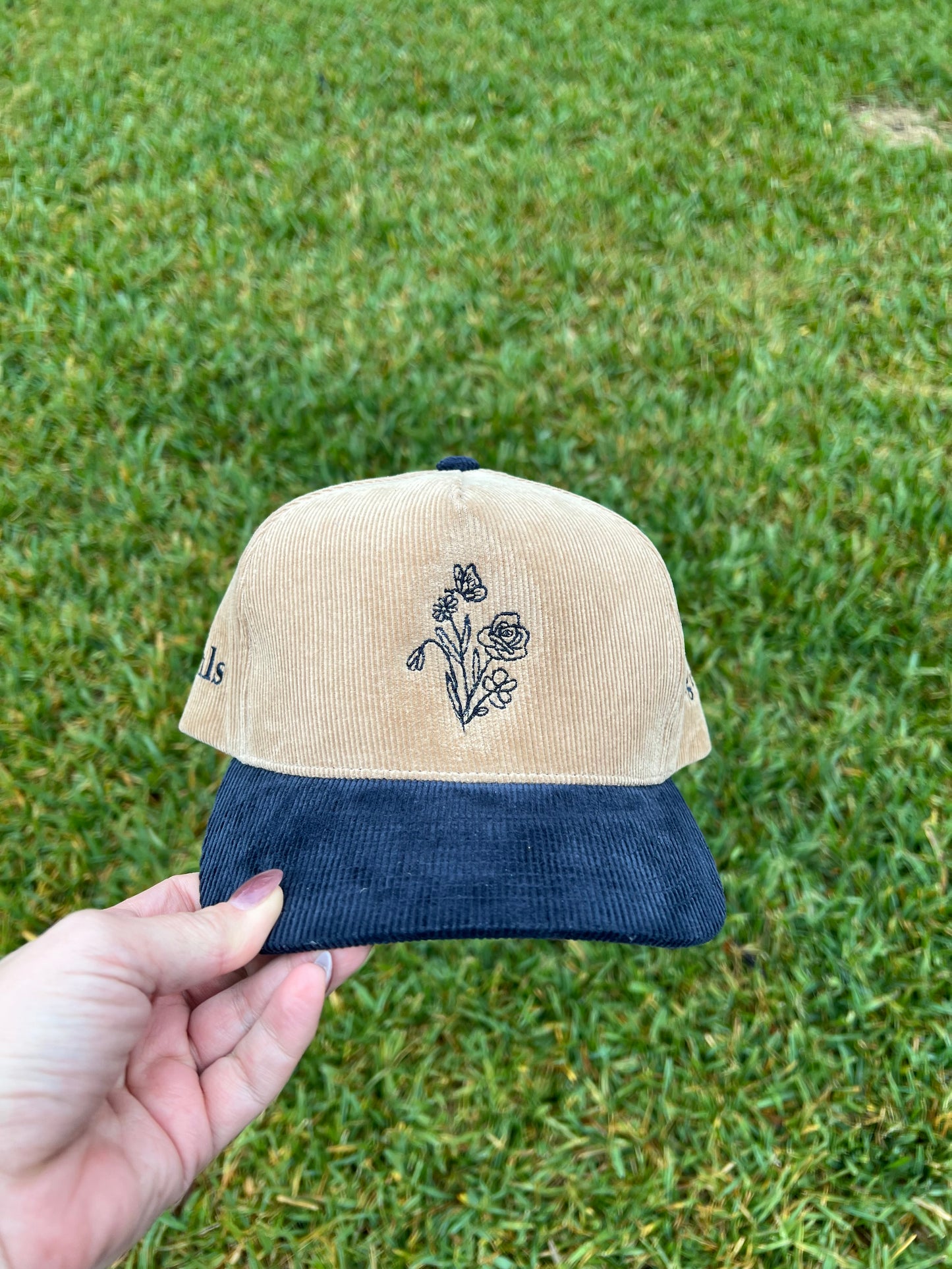 hlsembroidery signature floral detail embroidered on front of beige and navy corduroy hat 