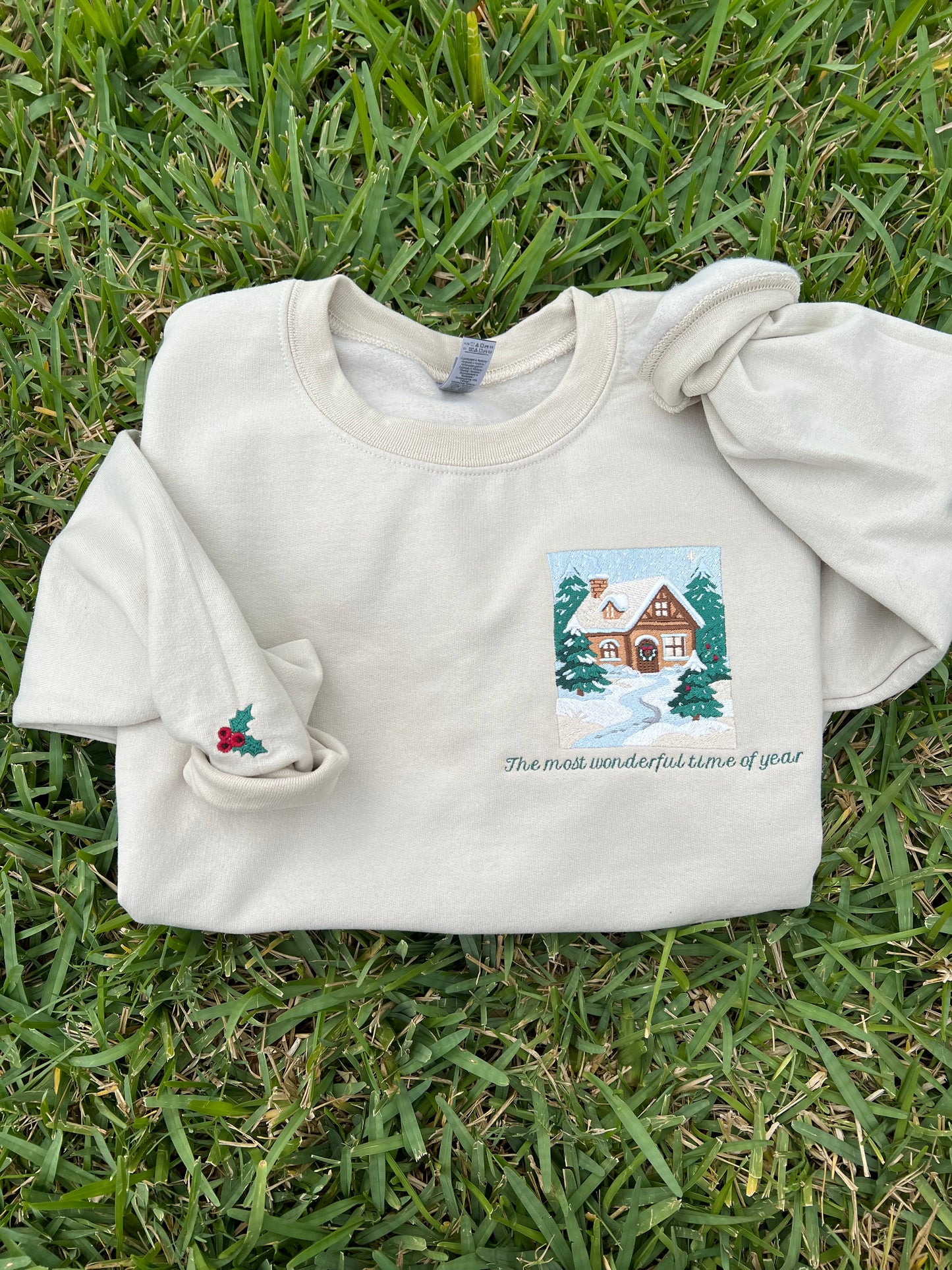 Embroidered Crewneck -with the words "The most wonderful time of year below a snowy scenic cabin