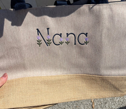 Nana wording in tulip embroidery font on the front of the tote bag