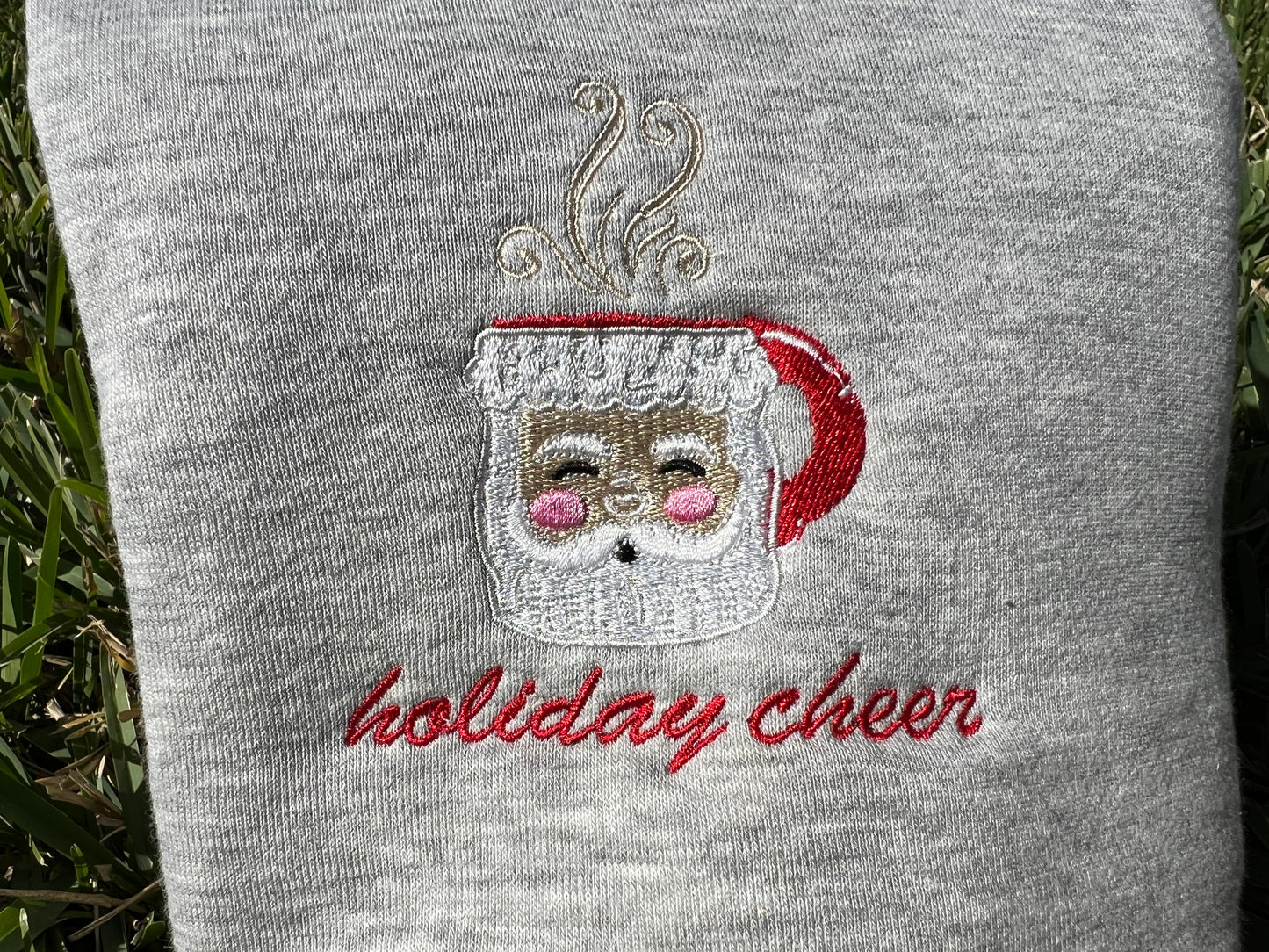 Gray Fabric with Santa mug embroidery with wording "holiday cheer"
