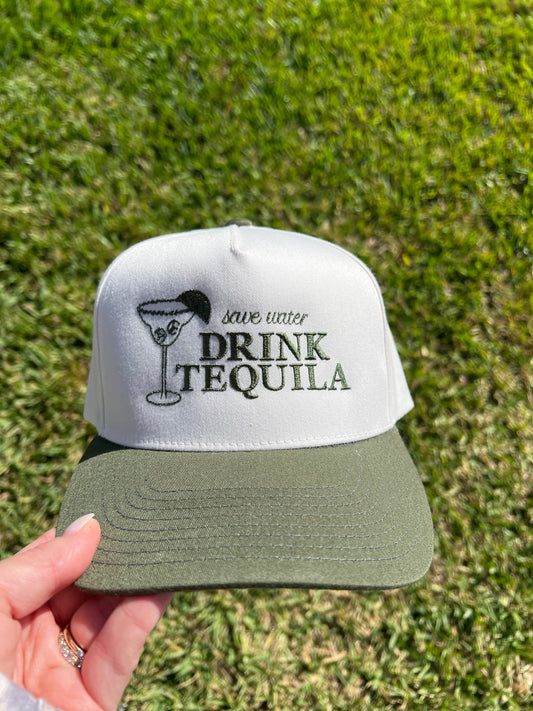 Cream and Green Cap with 'Save water Drink Tequila' text embroidery held against a blue sky
