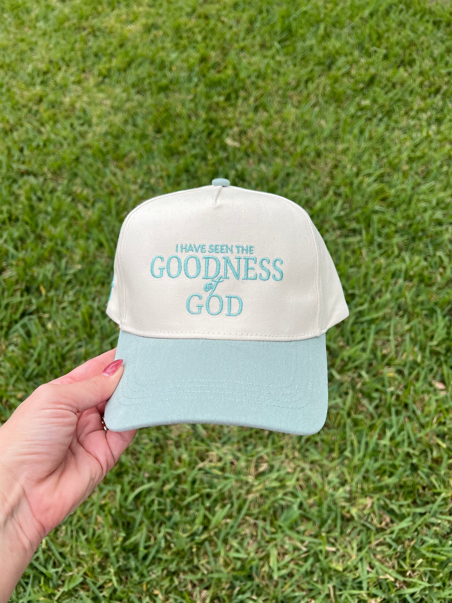 Sage and beige hat with "I have seen the goodness of god"