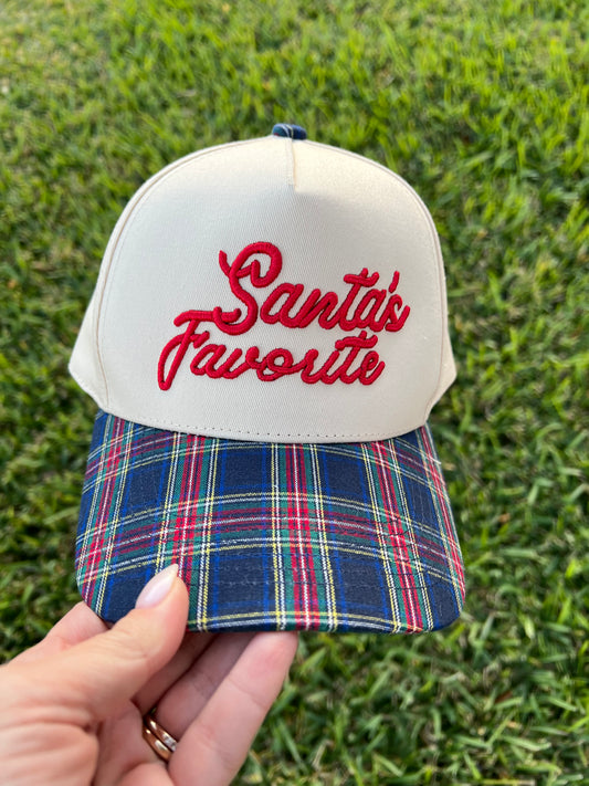 beige and plaid cap with puff embroidery with the text "Santa's Favorite"