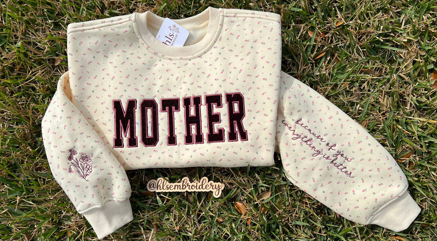 Mother appliqué embroidery on a butter yellow floral crewneck with sleeve embroidery detail 