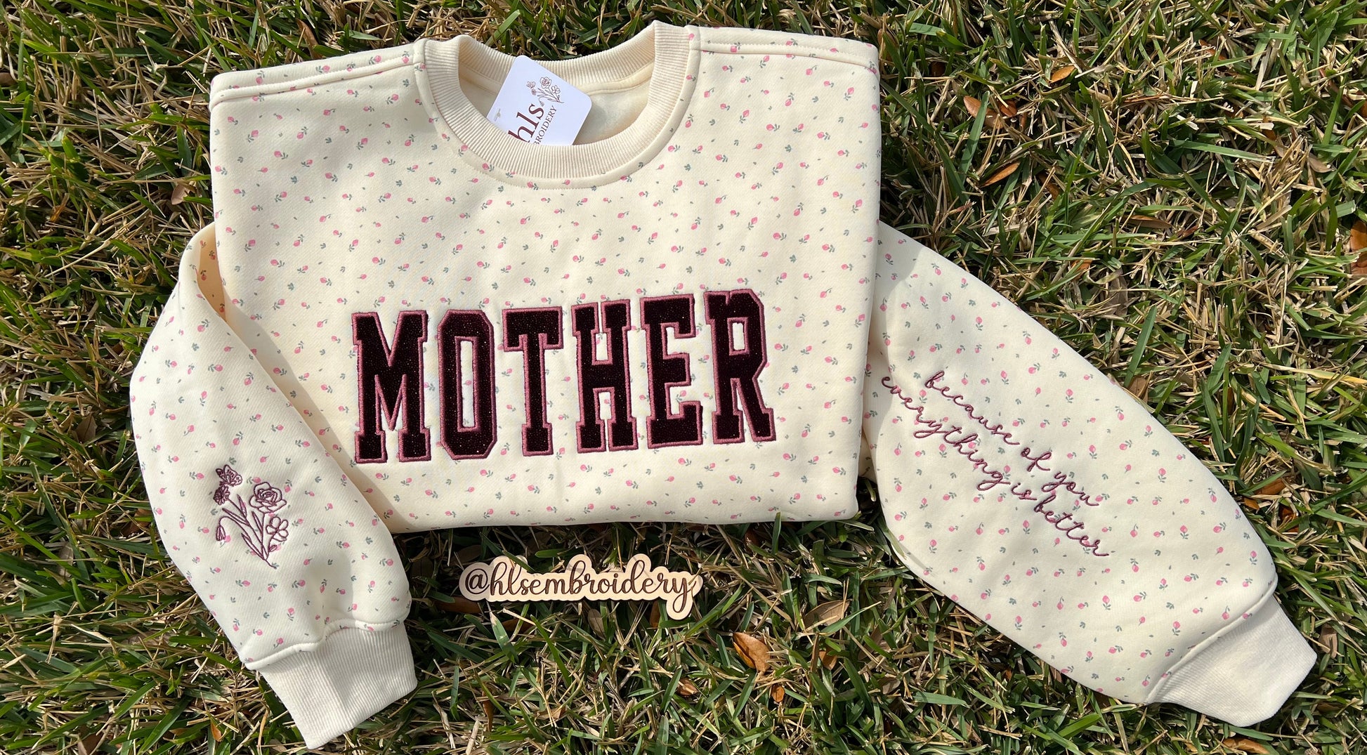 Mother appliqué embroidery on a butter yellow floral crewneck with sleeve embroidery detail 