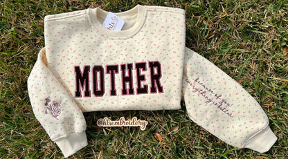 Mother appliqué embroidery on a butter yellow floral crewneck with sleeve embroidery detail 