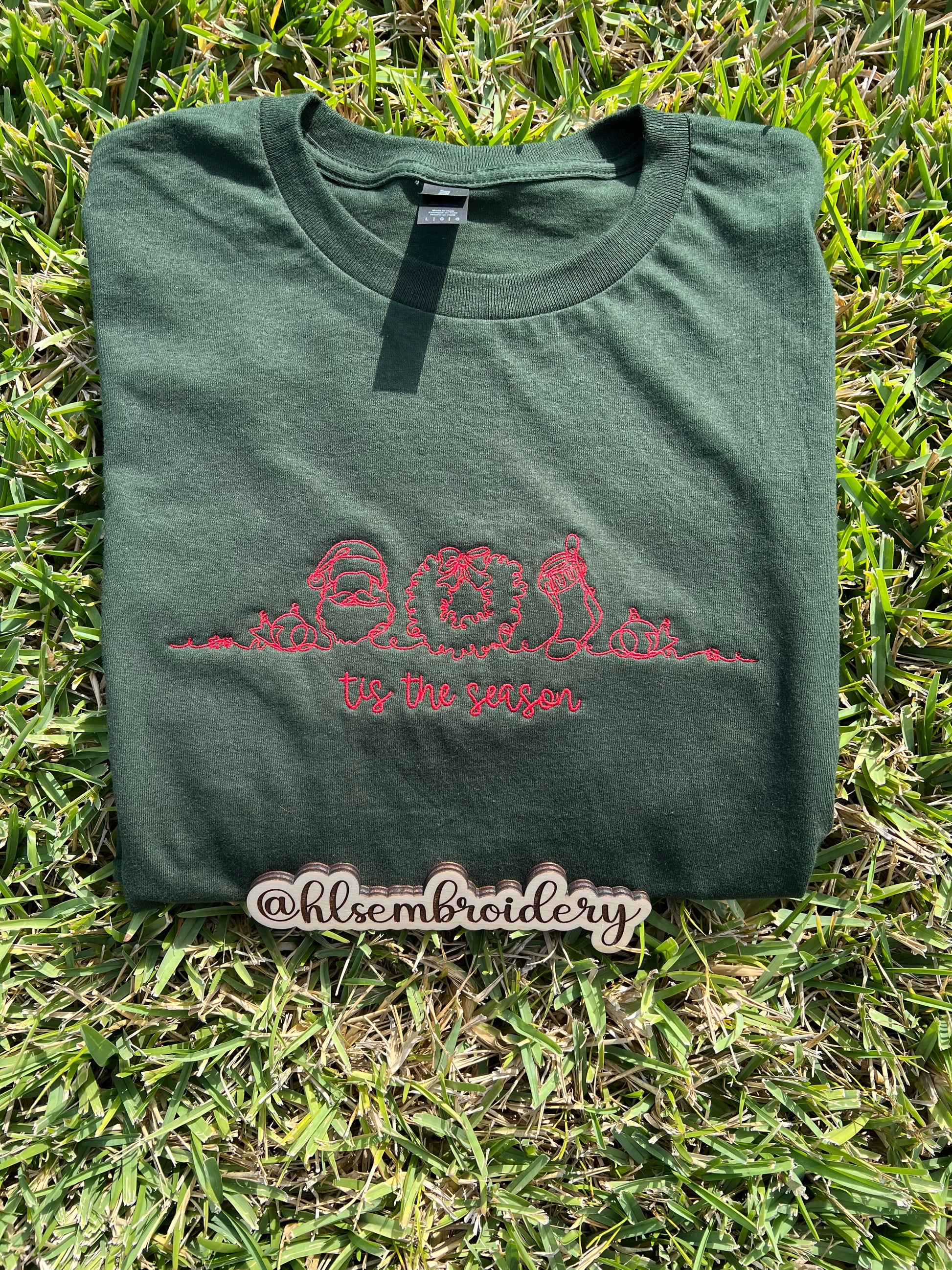 Green t-shirt with red embroidery design