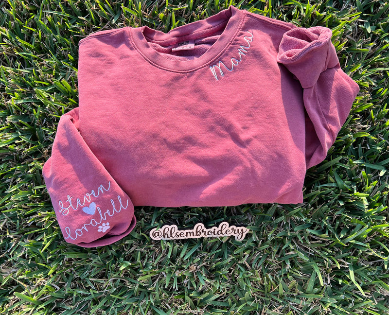 crimson color crewneck with Name embroidery on the neck and embroidery on the sleeve. 