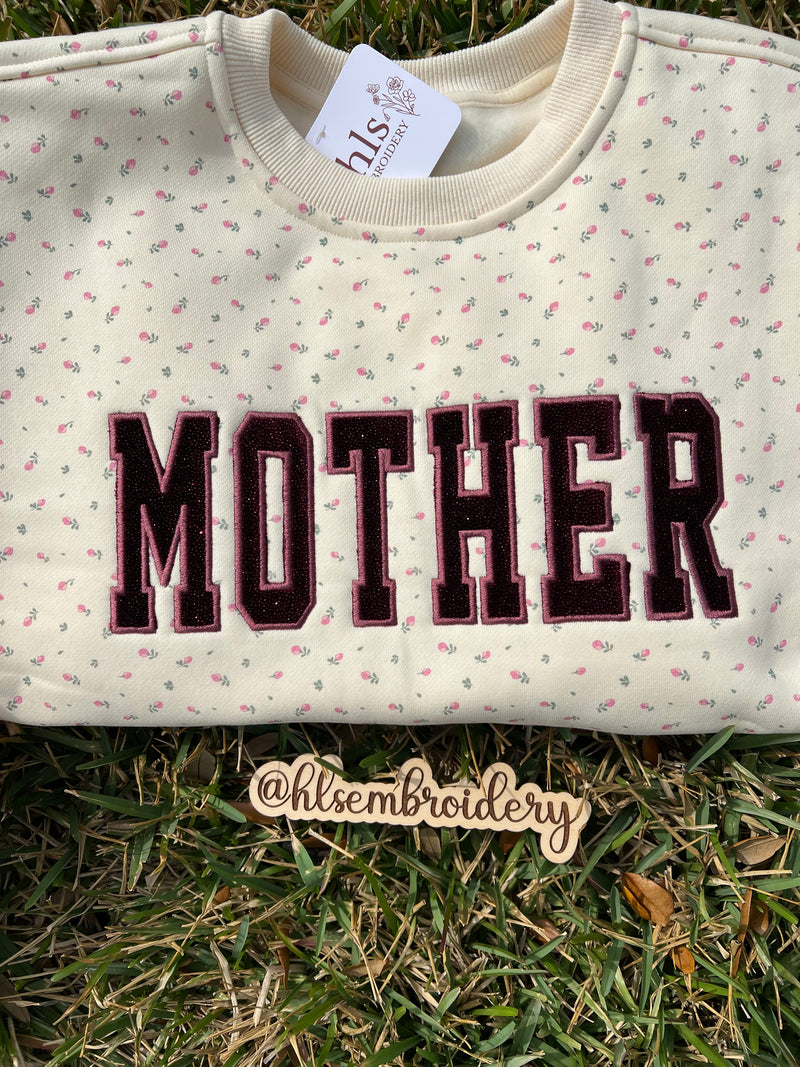  Mother appliqué embroidery on a butter yellow floral crewneck 