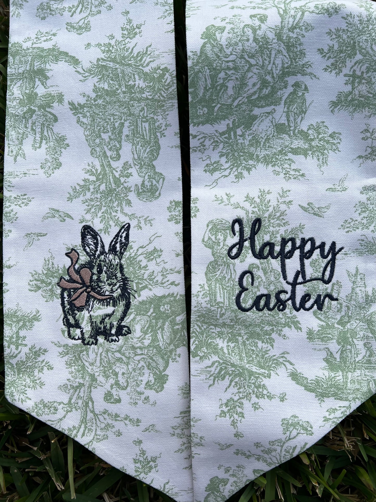 Green Toile Wreath sash with bunny and bow and happy Easter embroidered on it. 