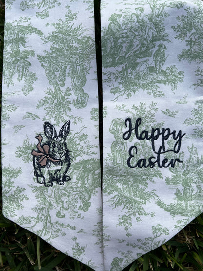 Green Toile Wreath sash with bunny and bow and happy Easter embroidered on it. 