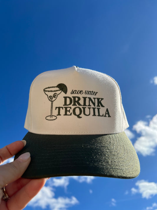 Cream and Green Cap with 'Save water Drink Tequila' text embroidery held against a blue sky