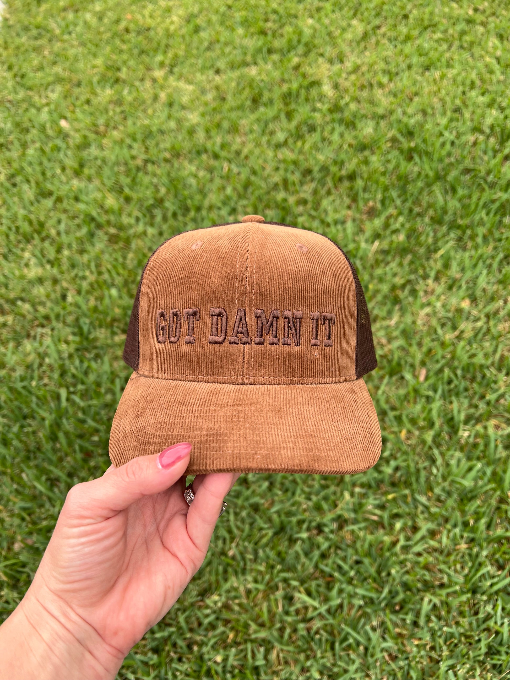 Brown Corduroy cap with the words "got damn it" embroidered in puff 