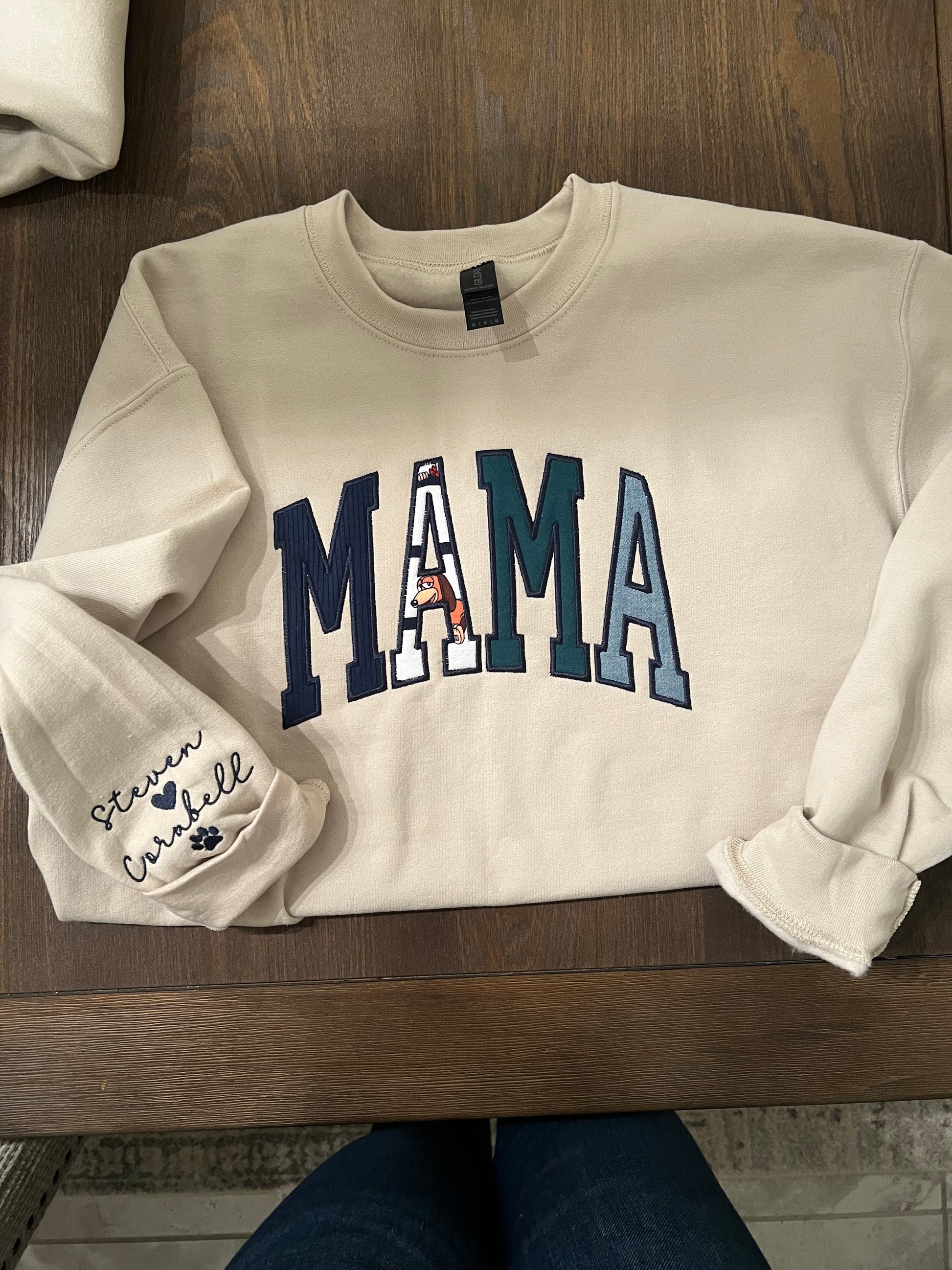 Mama embroidered crewneck using baby clothing and sleeve embroidered detail. 