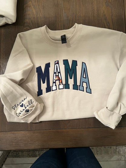 Mama embroidered crewneck using baby clothing and sleeve embroidered detail. 