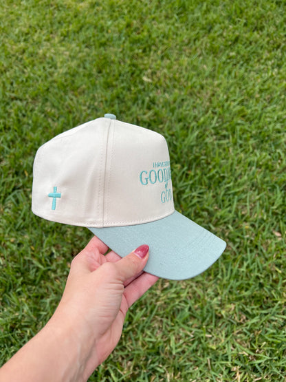 Sage and beige hat with "I have seen the goodness of god" with a cross on the side 