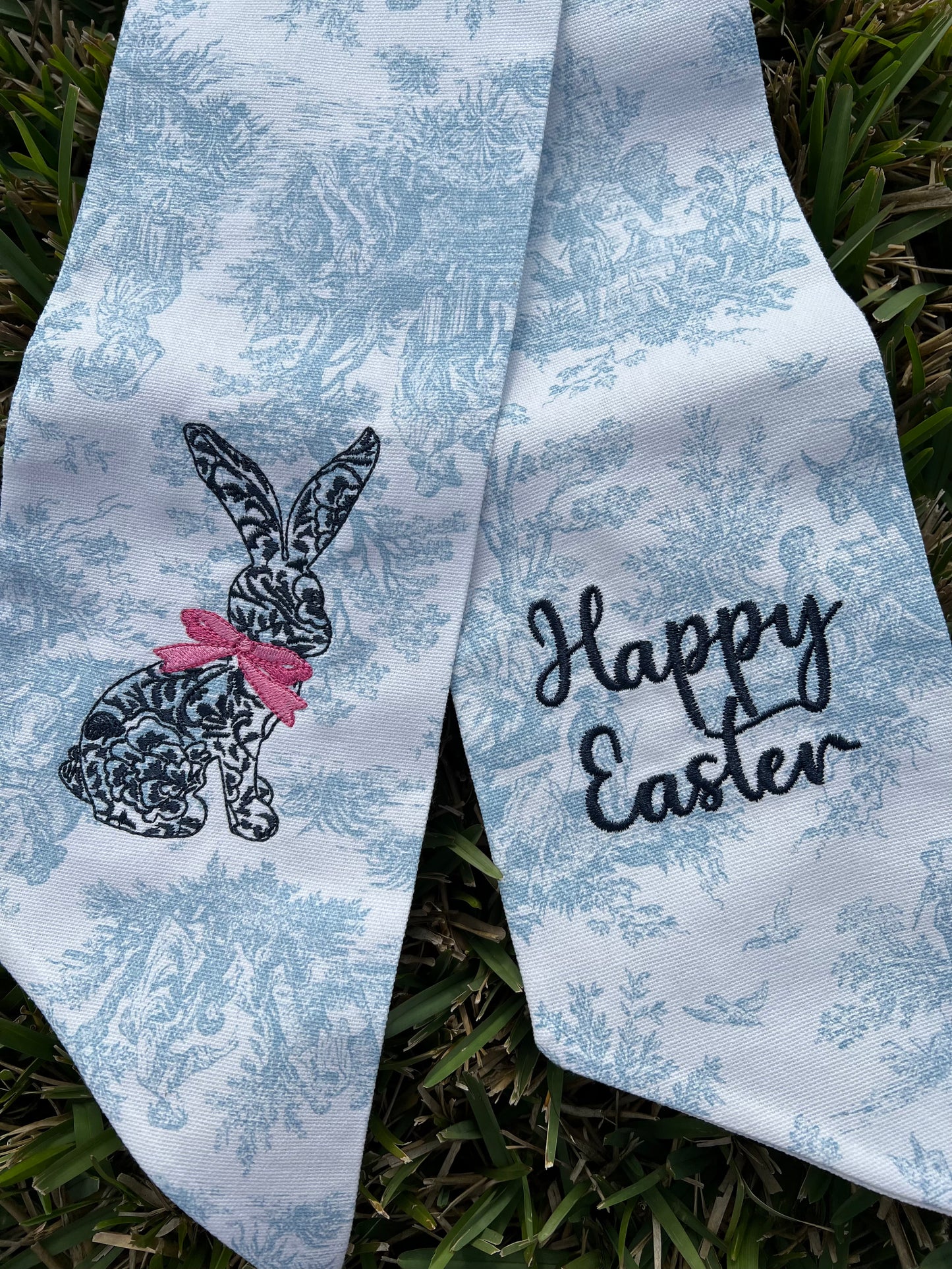 Blue toile wreath sash with a rabbit design and 'Happy Easter' text