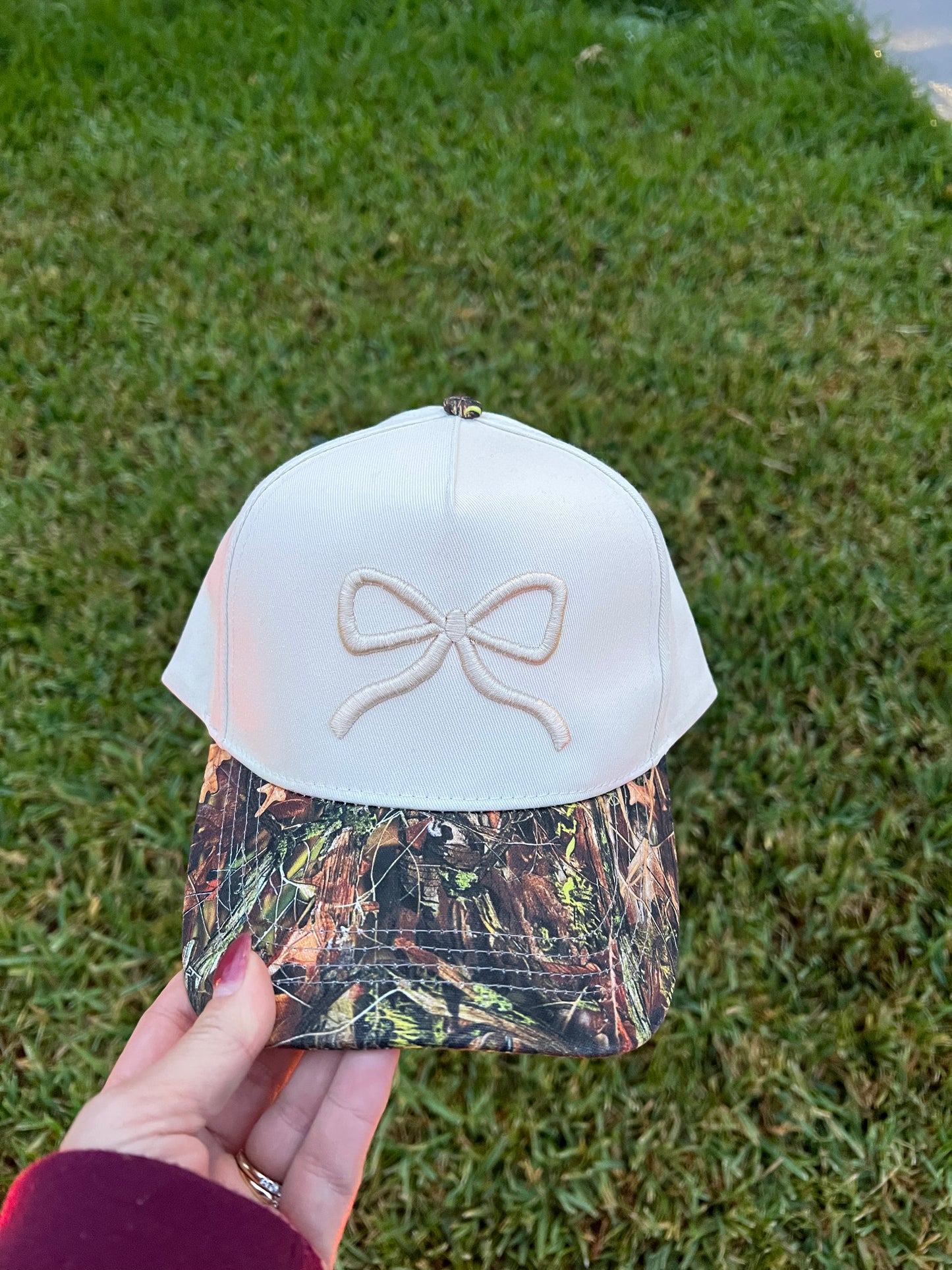Cap with a bow design on a grassy background