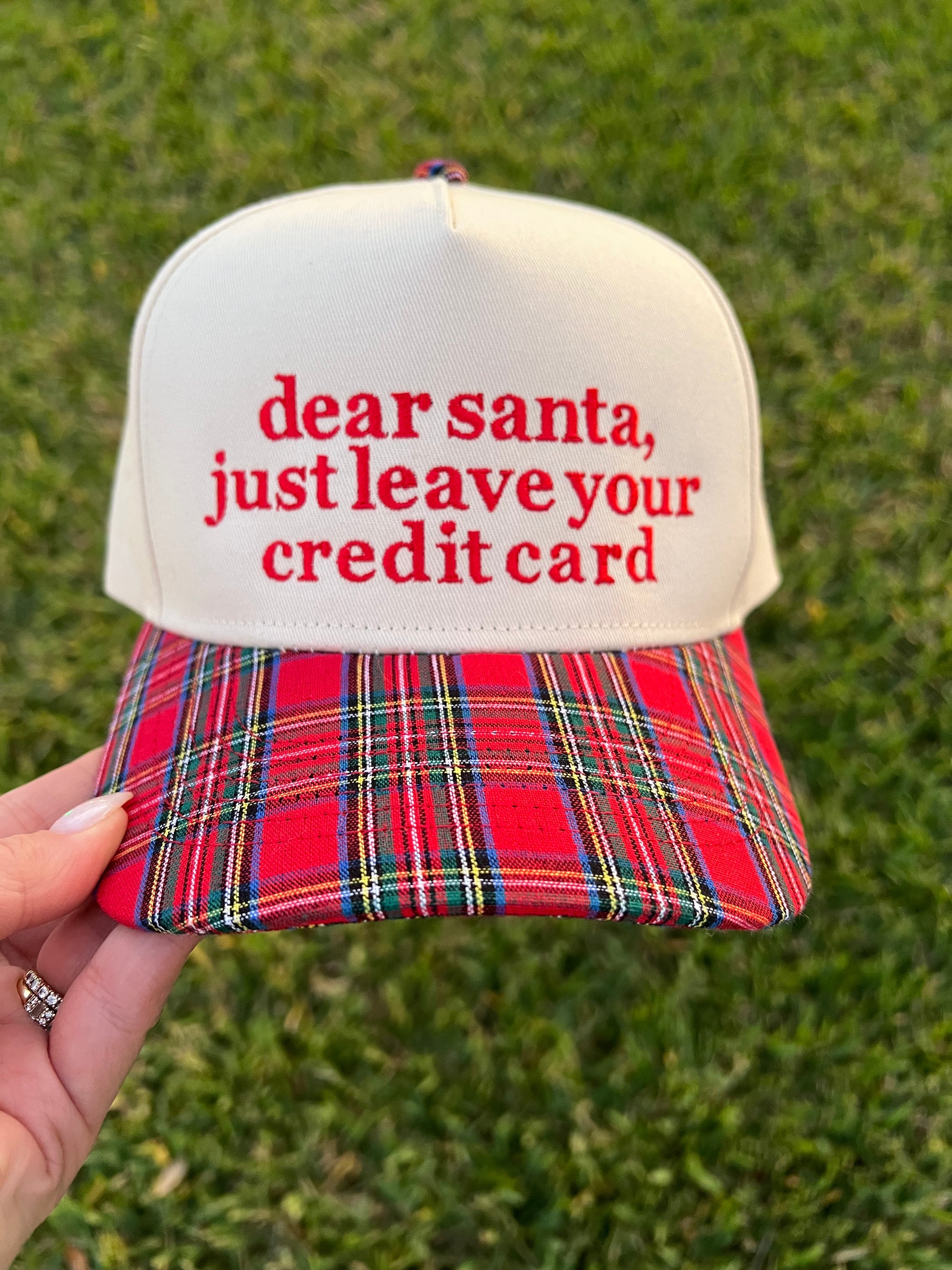 plaid and beige cap with wording on the front in embroidery. 