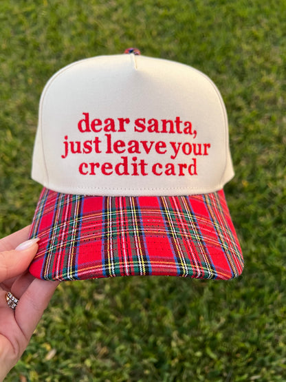 plaid and beige cap with wording on the front in embroidery. 