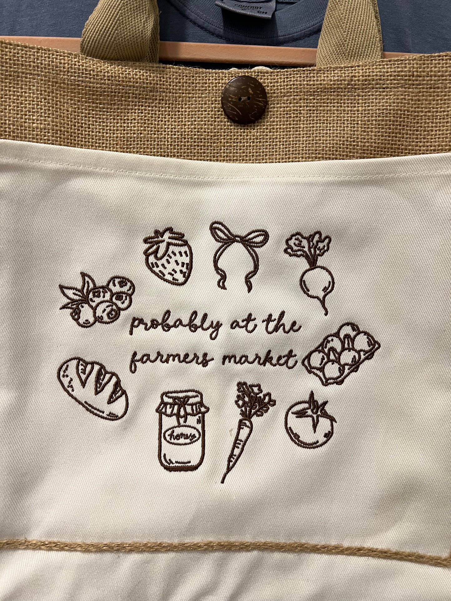 Tote bag with farmer's market-themed illustrations and text.