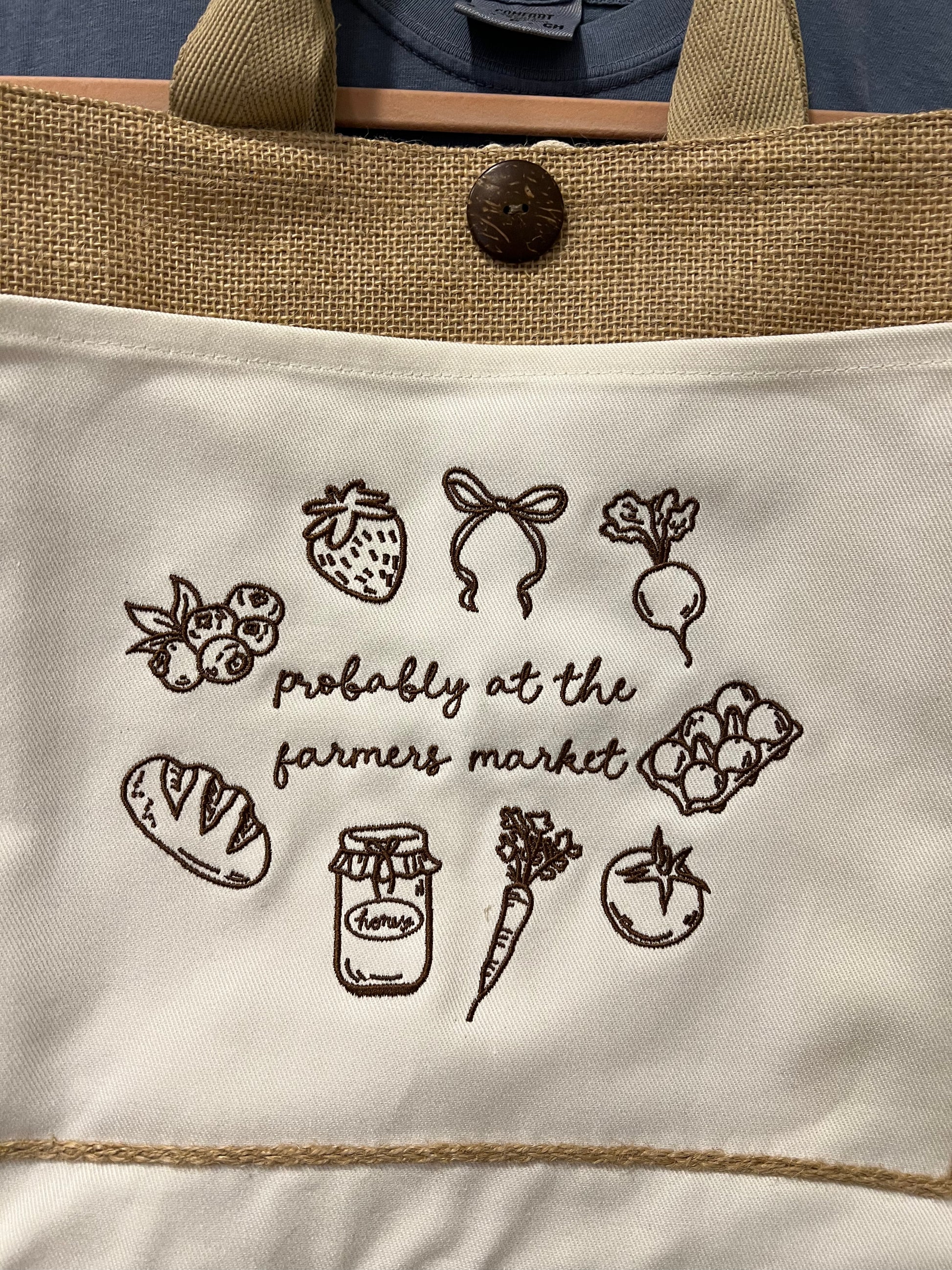 Tote bag with farmer's market-themed illustrations and text.