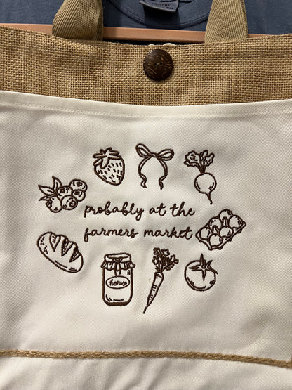 Tote bag with farmer's market-themed illustrations and text.
