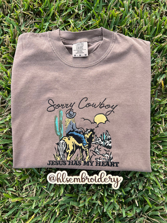 Folded t-shirt with 'Sorry Cowboy Jesus Has My Heart' embroidery design 