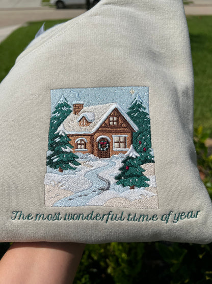 Embroidered Crewneck -with the words "The most wonderful time of year below a snowy scenic cabin