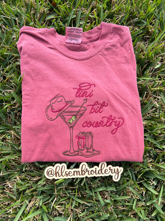 Comfort colors crimson t-shirt with 'tini bit country' design embroidered on it 