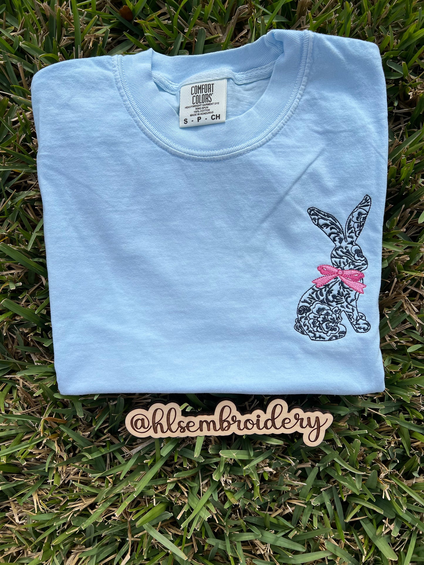 Light blue sweatshirt with a embroidered bunny embroidered on it