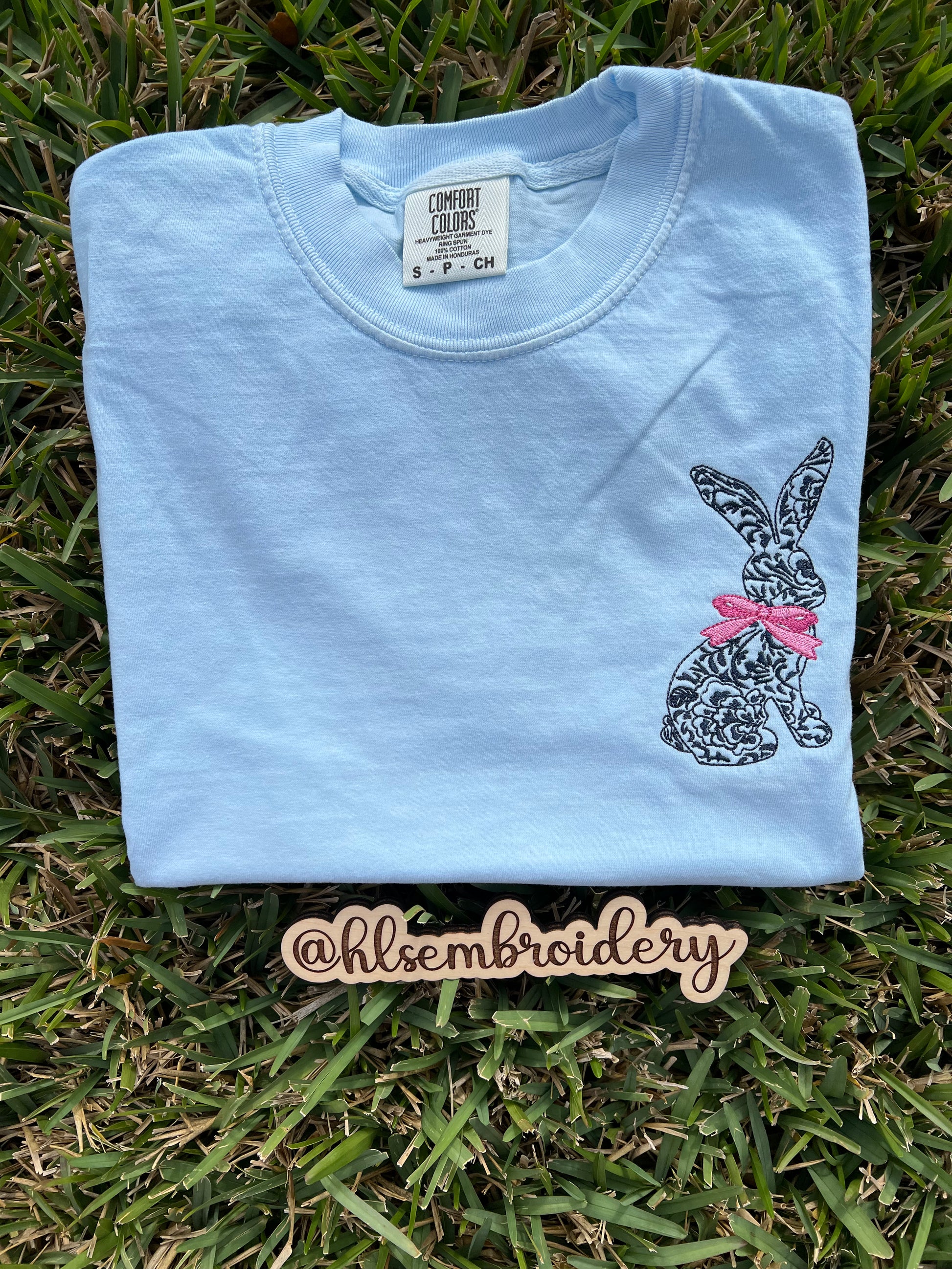 Light blue sweatshirt with a embroidered bunny embroidered on it