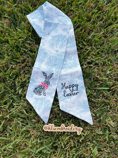 Blue toile wreath sash with a rabbit design and 'Happy Easter' text