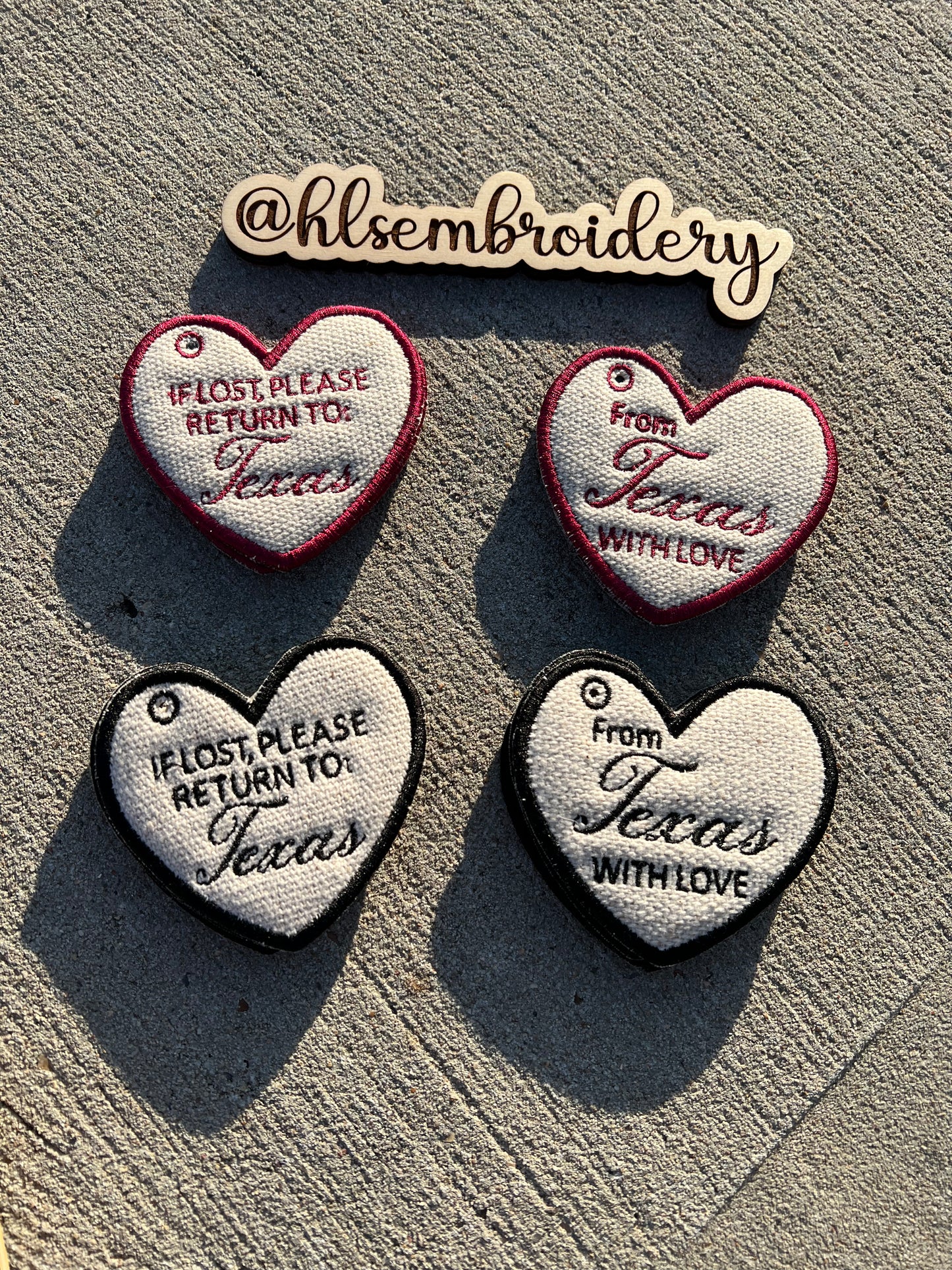 Heart shaped Keychains with embroidered text on them. 