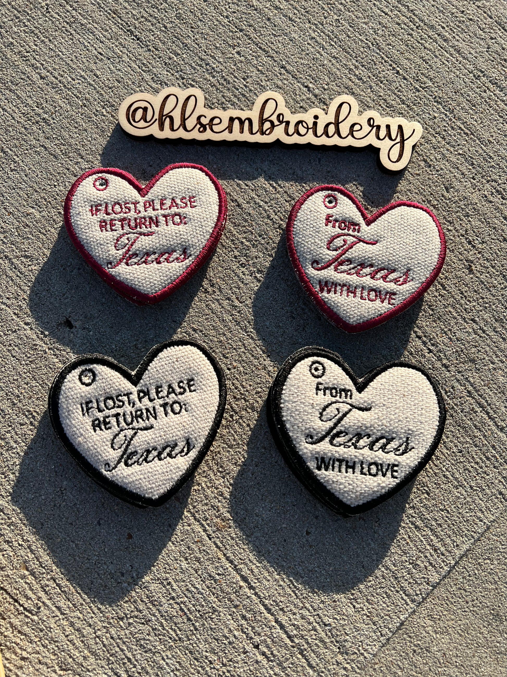 Heart shaped Keychains with embroidered text on them. 