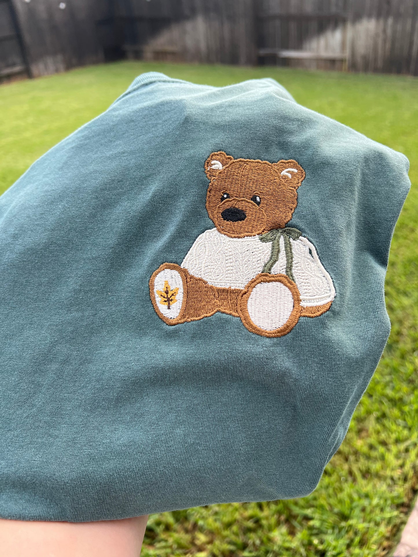 Green shirt with a teddy bear applique embroidery