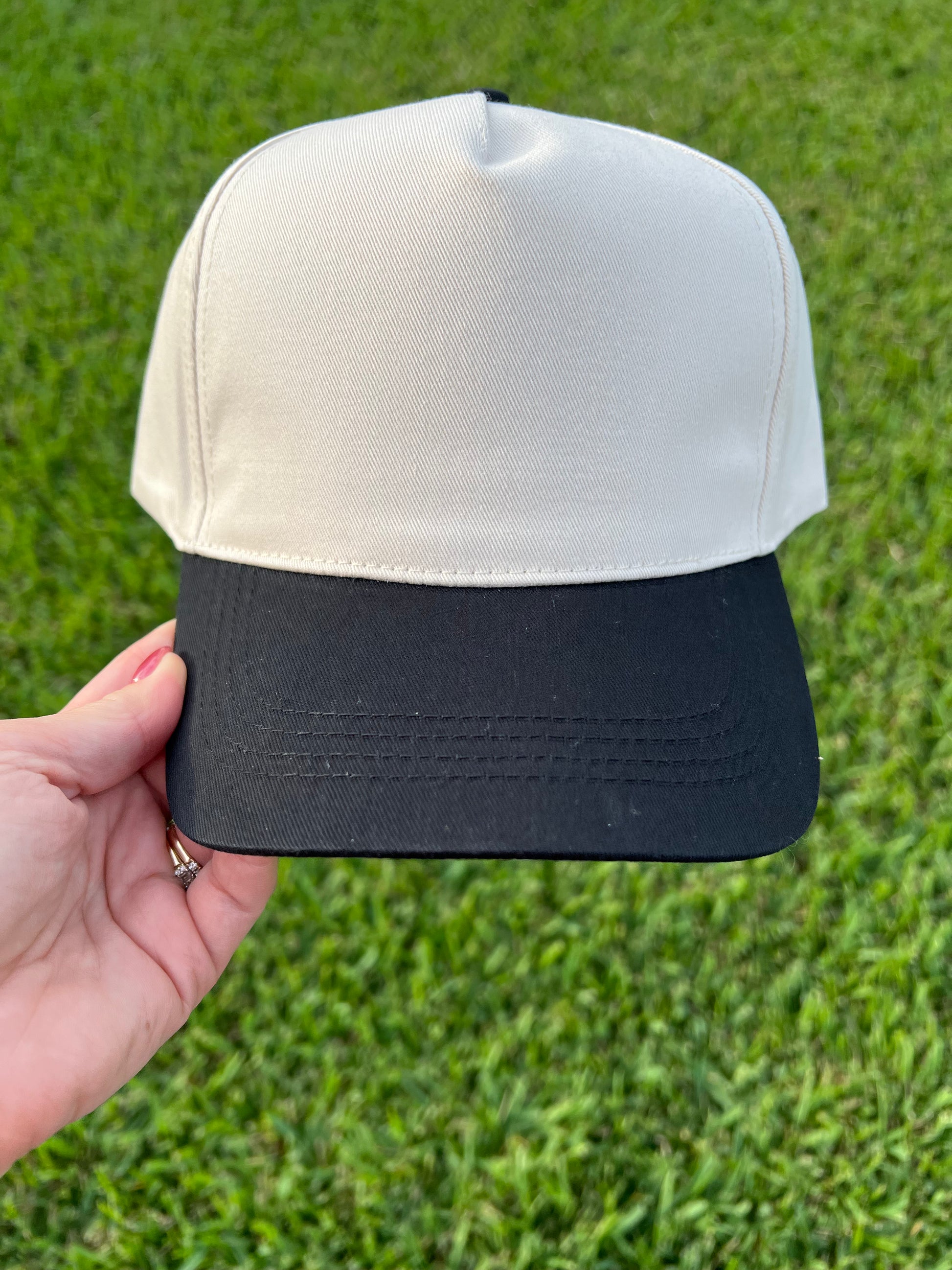 beige and black cap 