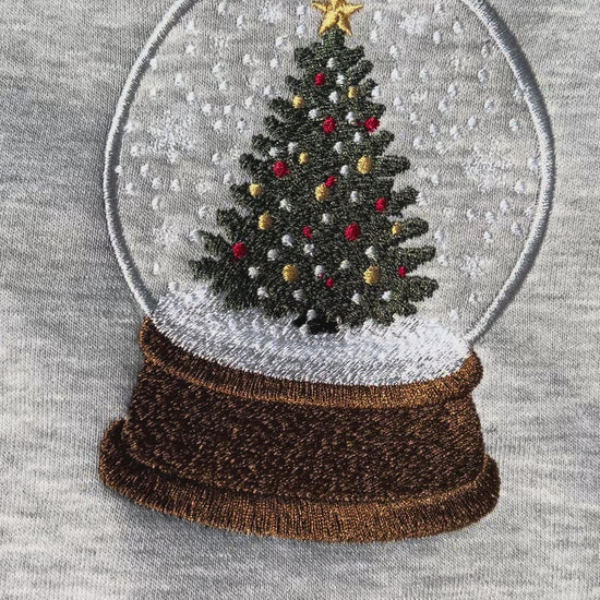 Gray sweatshirt with a Christmas tree snow globe design on a gray background
